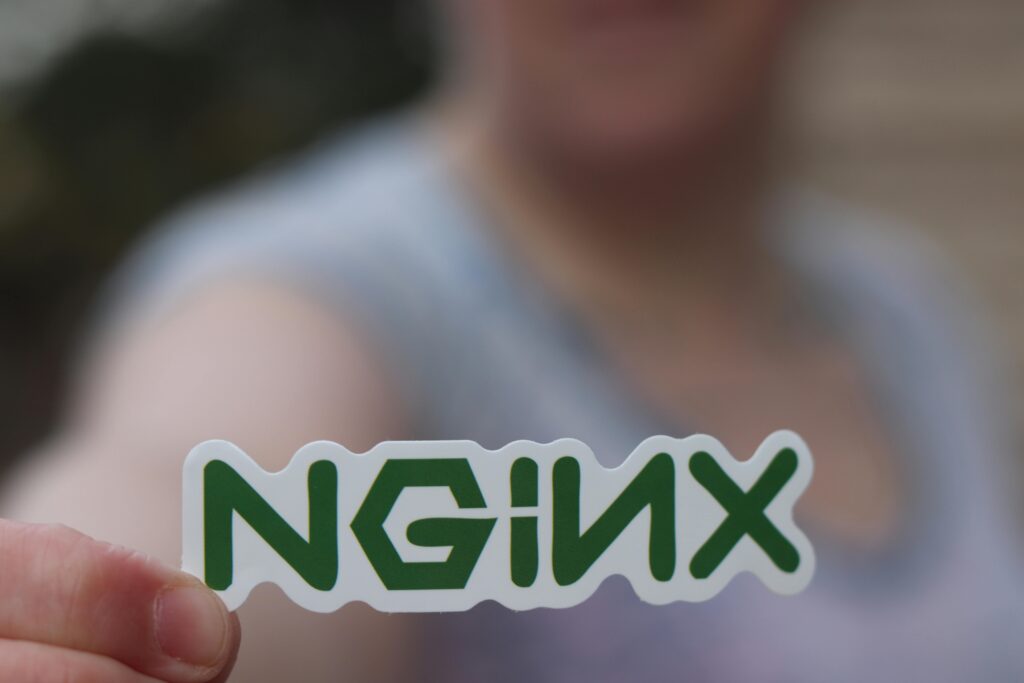 Person Holding a Sticker with Green Letters